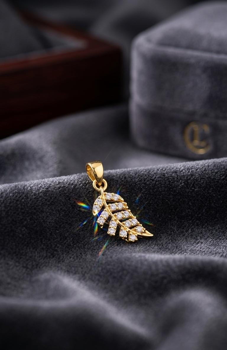 Leaf inspired gold pendant with sparkling stones 